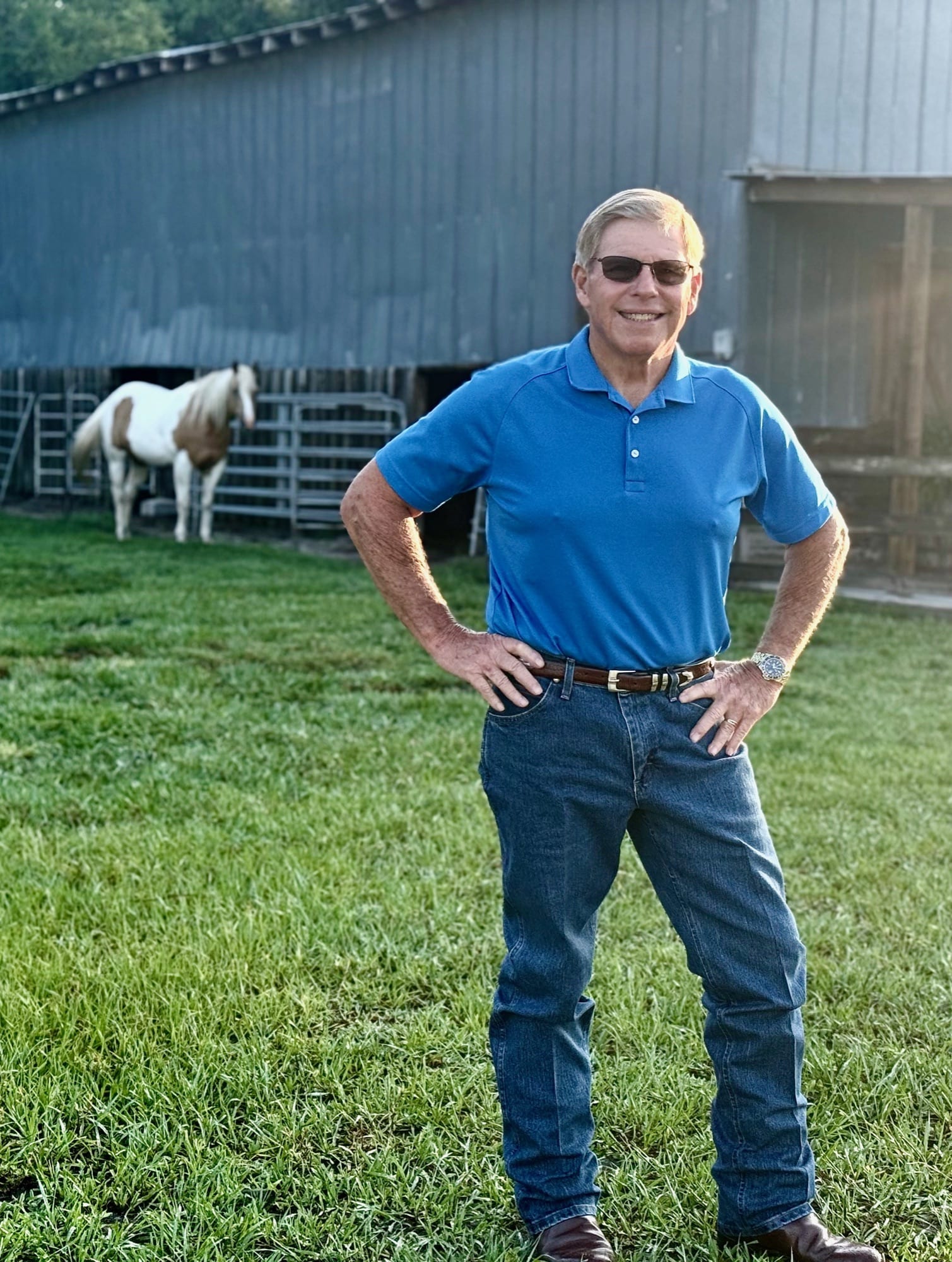 Rick Wilson outside the barn on the family ranch in Bartow, with a horse in the background