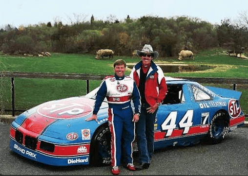 Rick Wilson and Richard Petty beside the Petty Enterprises No. 44 stock car